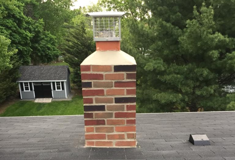 New brick chimney with chimney cap, Lasting Construction LLC