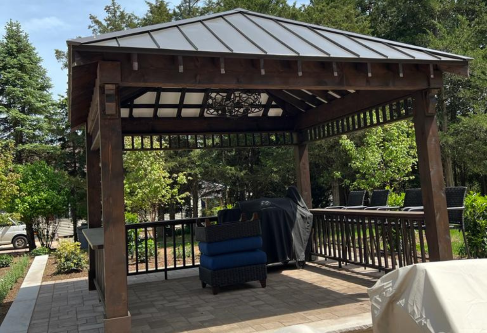 Custom built hard wood gazebo with railing, courtesy of Lasting Construction LLC