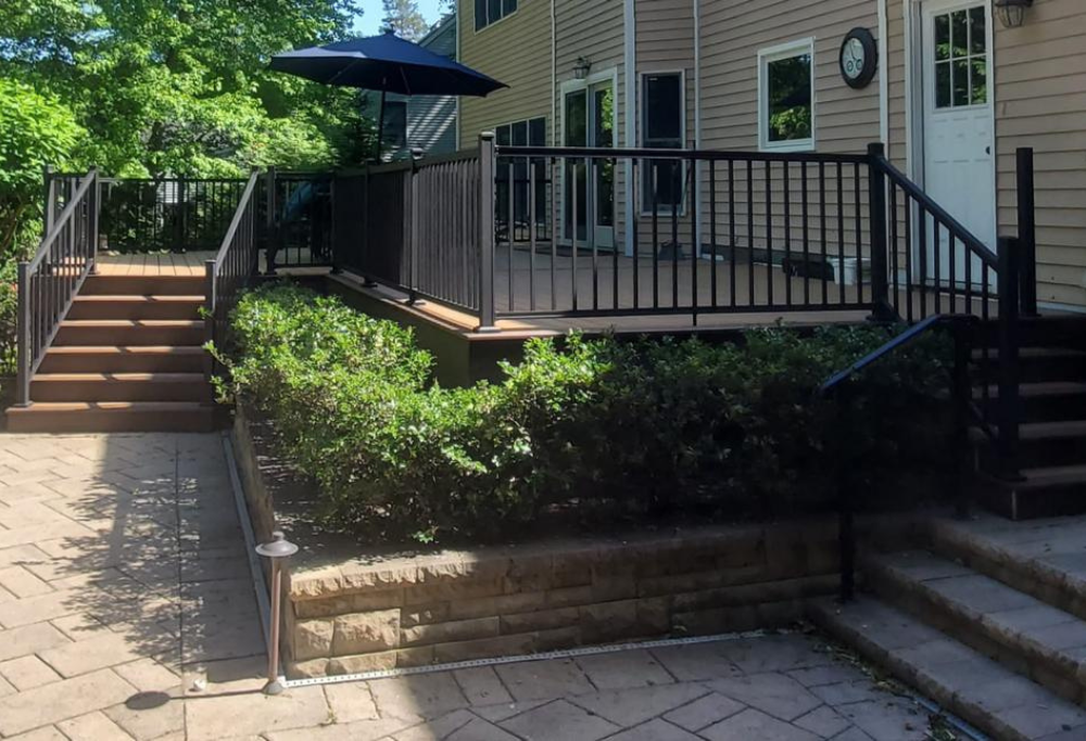 View of back porch and steps with sturdy metal railing, courtesy of Lasting Construction LLC